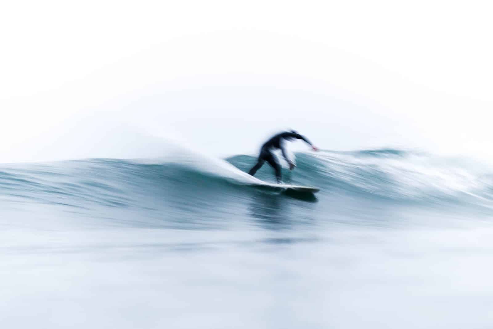person on surfboard riding waves